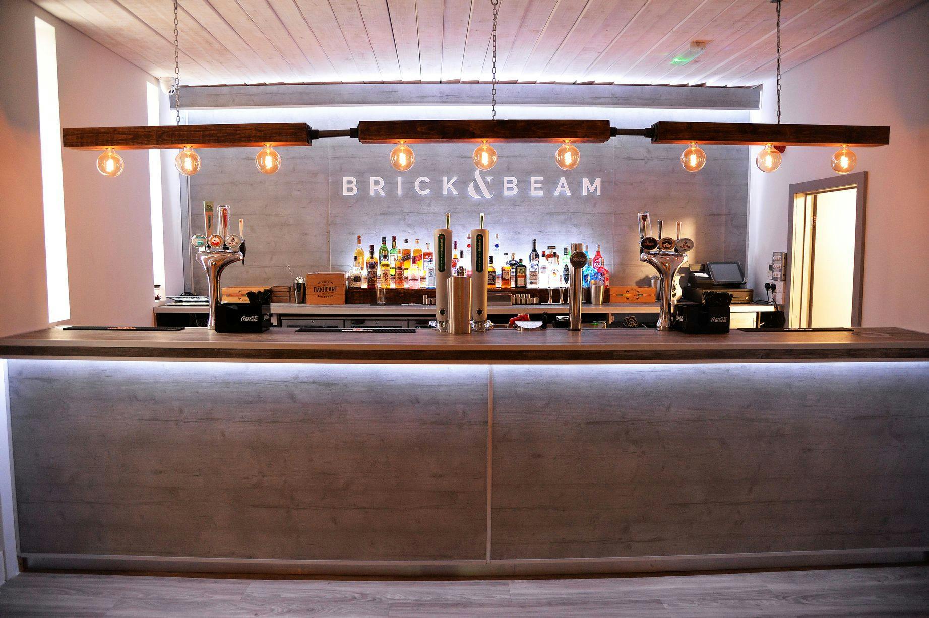 Sleek modern bar at Brick & Beam, ideal for events and social gatherings.