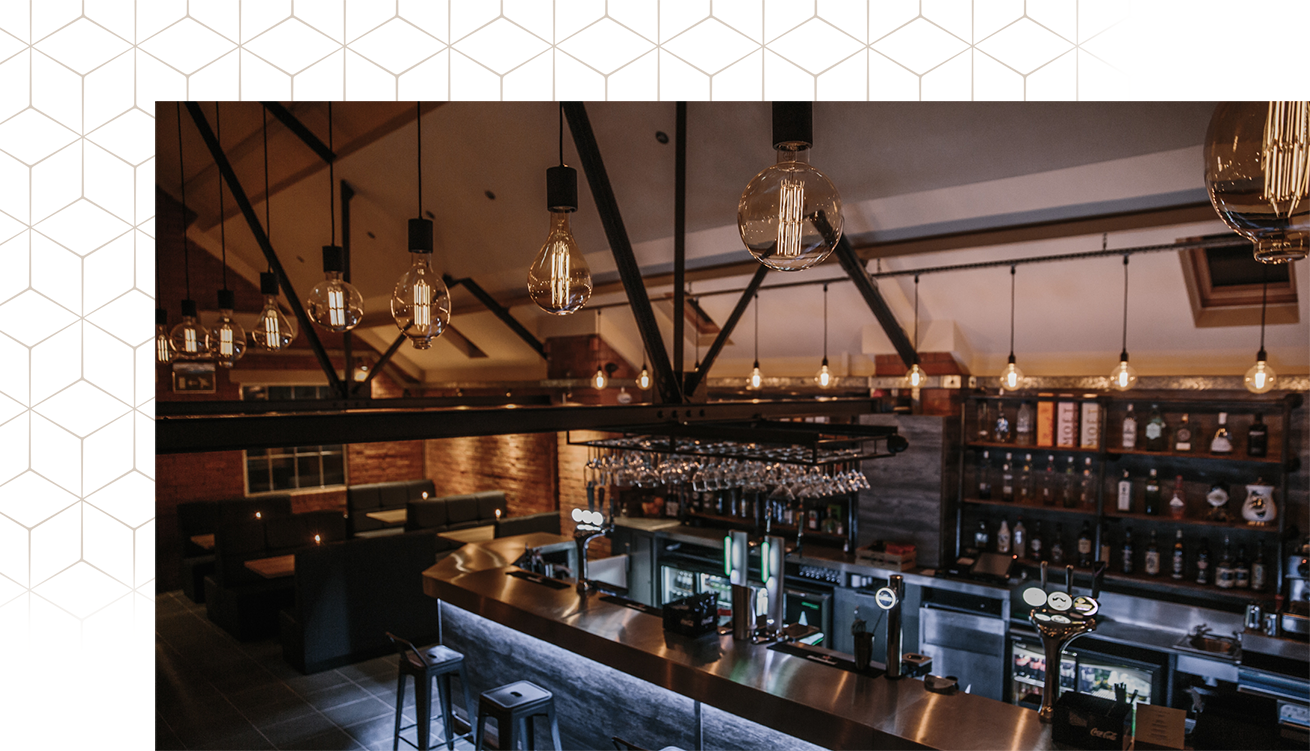 Stylish bar area at Brick & Beam, perfect for networking events and gatherings. - Banner