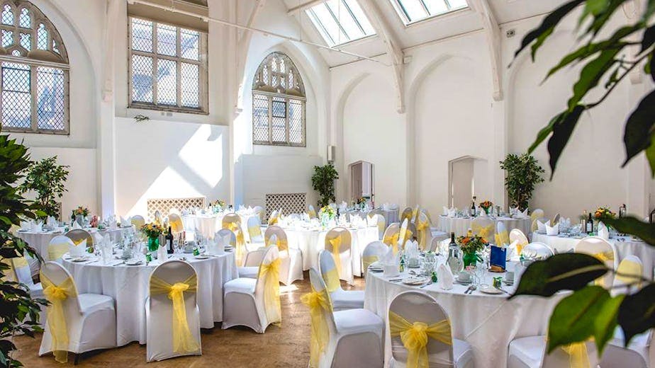 Main Room in The Old Library with round tables, ideal for weddings and corporate events.