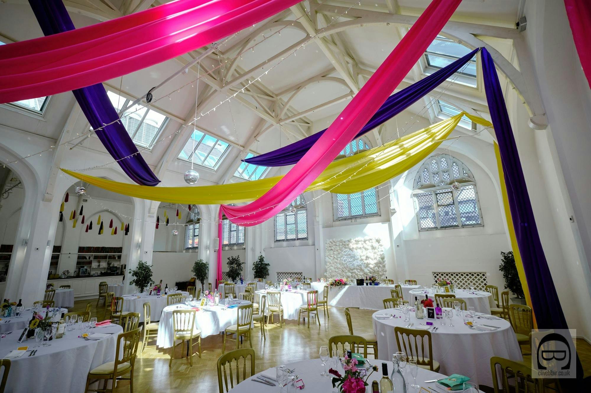 Ceremony in The Old Library with vibrant decor and floral centerpieces for events.