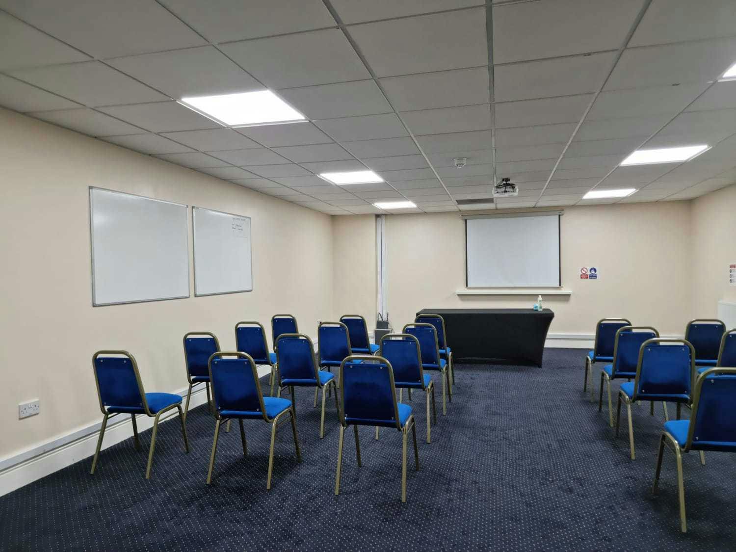 Versatile conference center with blue chairs, ideal for corporate meetings and workshops.