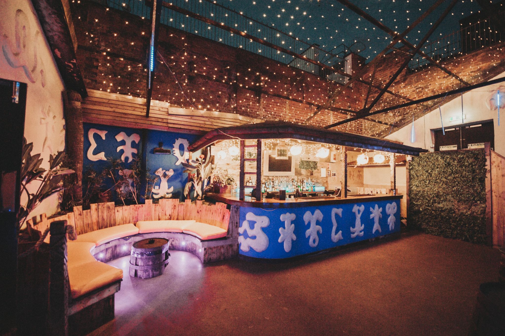 Tiki Garden Terrace bar with cozy seating, perfect for networking events and gatherings. - Banner