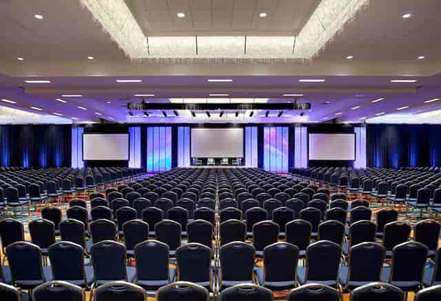 Spacious Marquis Ballroom in Anaheim Marriott set for corporate conference with stage and screens.