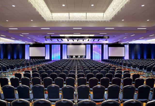 Spacious Marquis Ballroom in Anaheim Marriott set for corporate conference with stage and screens.