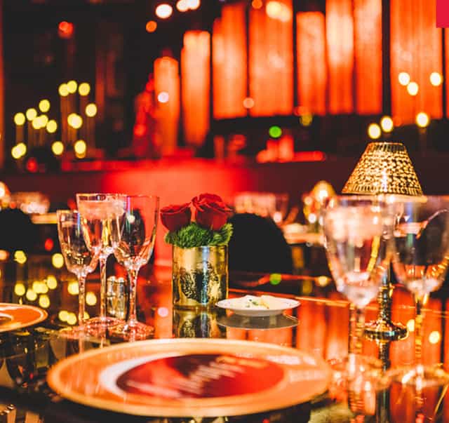 Elegant dining setup with floral centerpiece at North Island Credit Union Amphitheatre event.