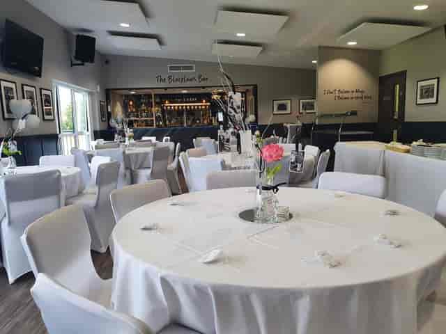 Elegant event space with round tables, perfect for meetings and receptions.