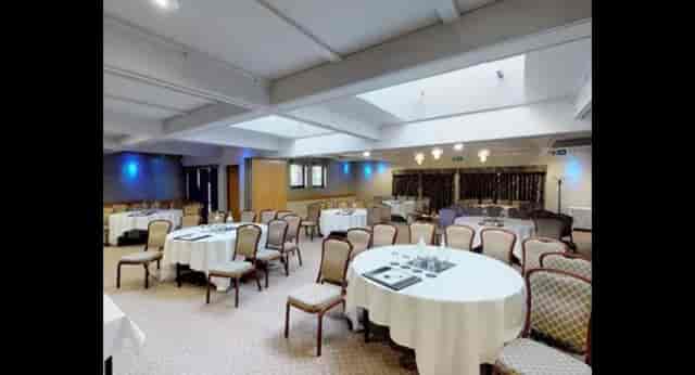 Versatile meeting room with round tables at Lea Marston Hotel for events and gatherings.