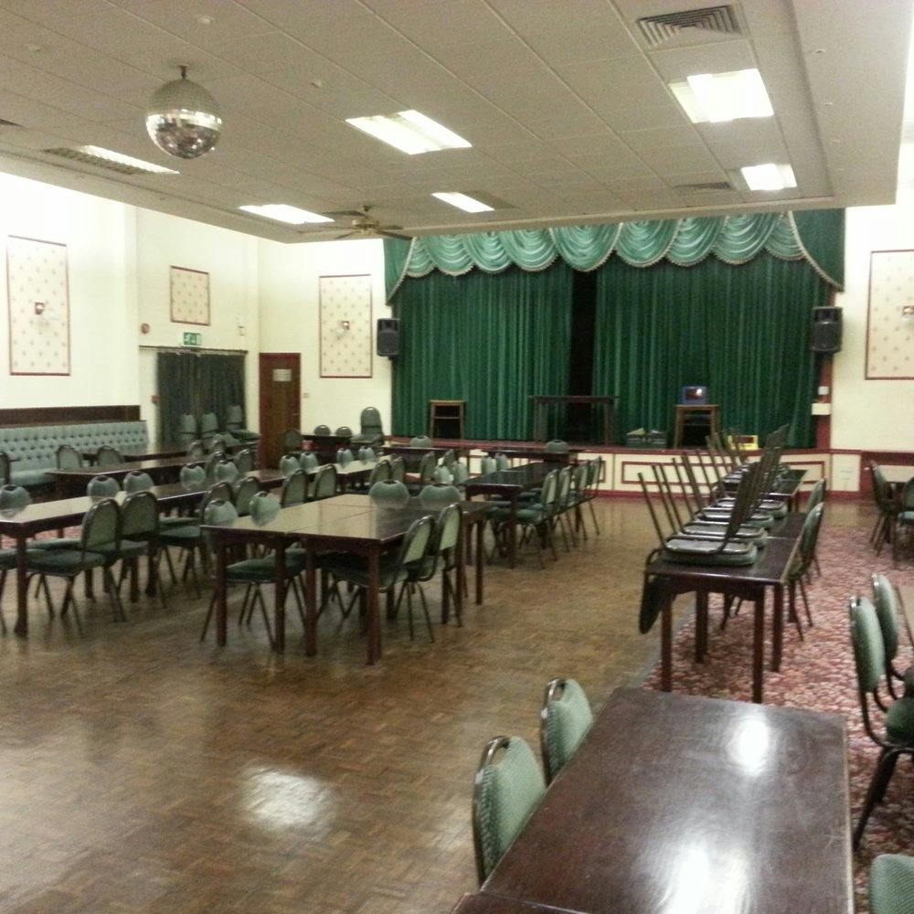 Spacious Harborne Village Social Club function room with stage, ideal for events and meetings.