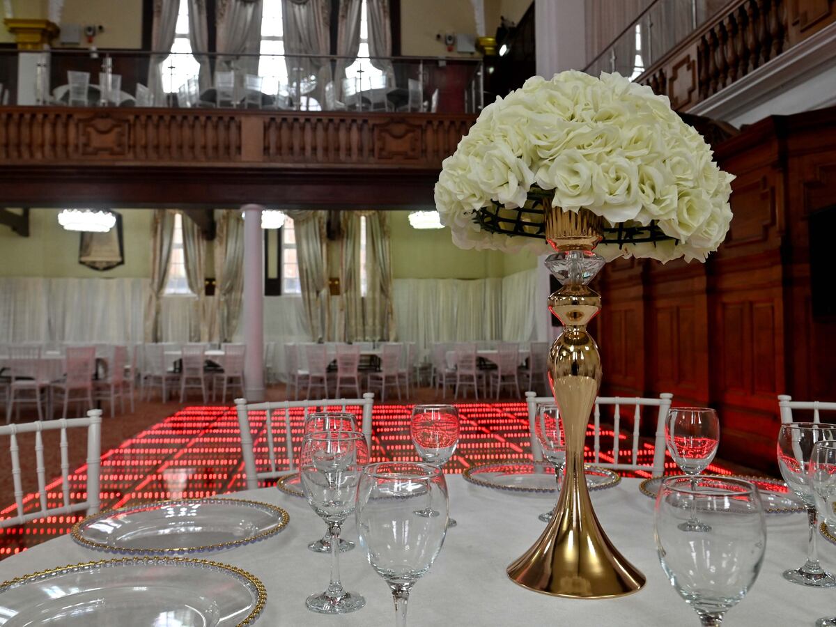 Elegant dining table with white roses at The Grand Palace for upscale events. - Banner
