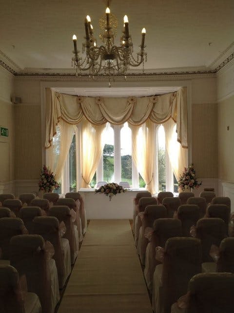 Carillon Flute and Guitar Duo in an elegant wedding venue with floral arrangements.