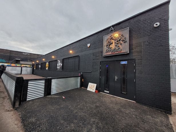 Modern beer garden venue with sleek black exterior, ideal for events and gatherings.