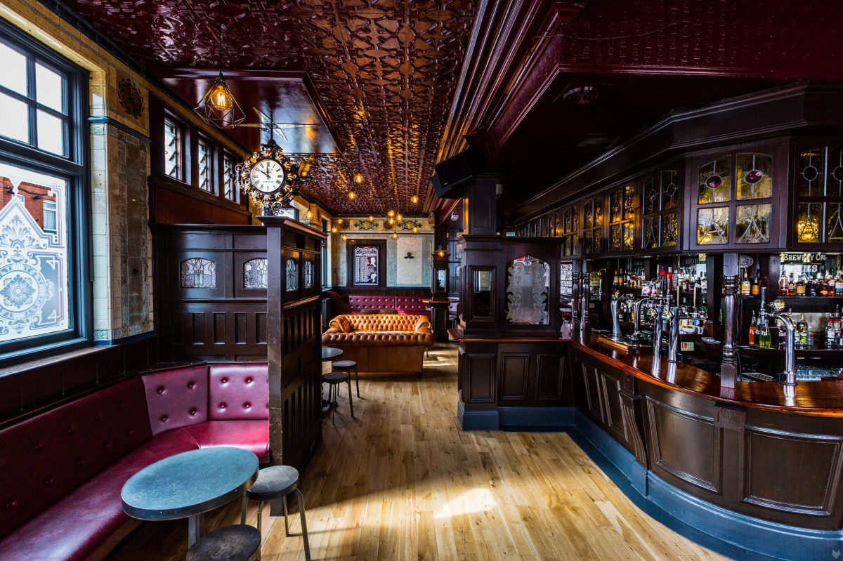 Stylish function room with warm wood finishes for intimate gatherings and cocktail receptions. - Banner