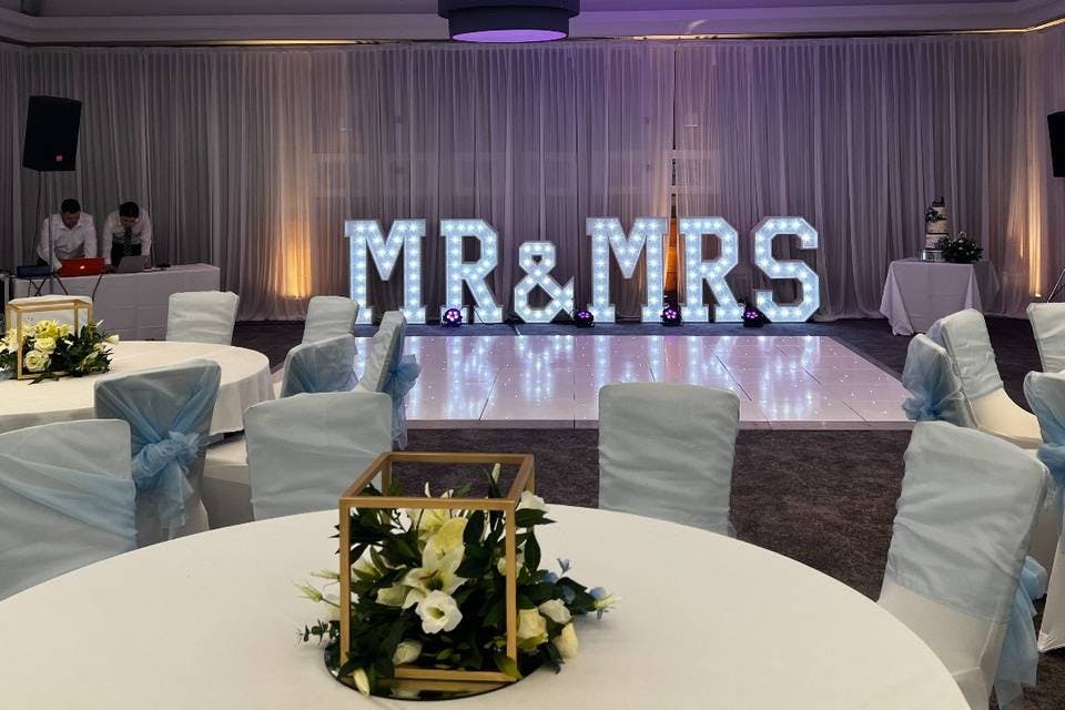 Function room at Village Hotel Solihull with "MR & MRS" sign, ideal for wedding receptions.