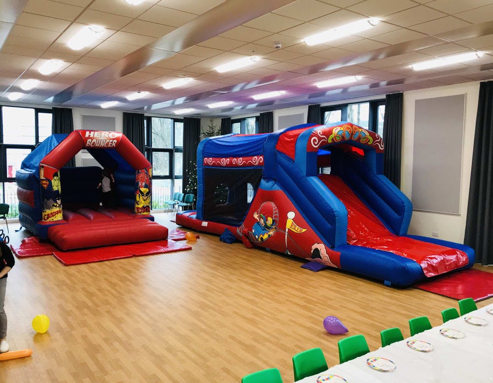 Cofton Hackett Village Hall with colorful bouncy castle and slide for family events.