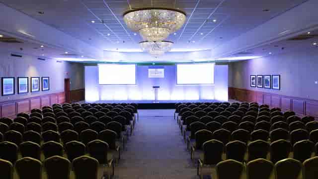 Conference room at The Belfry with elegant chandeliers, ideal for corporate events and seminars.