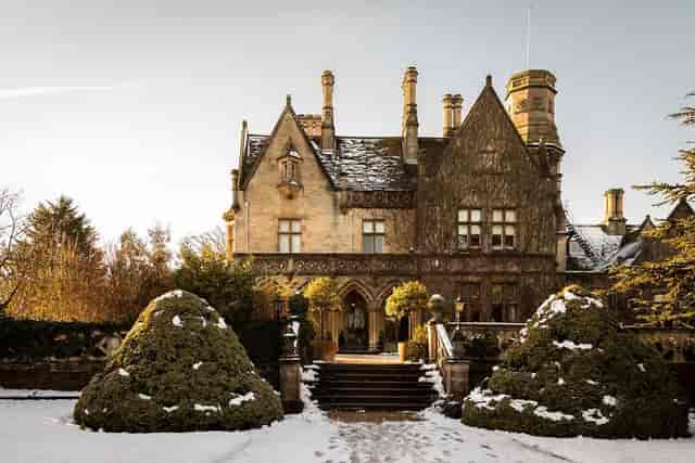 Manor Arches mansion with snow, ideal for upscale winter events and gatherings.