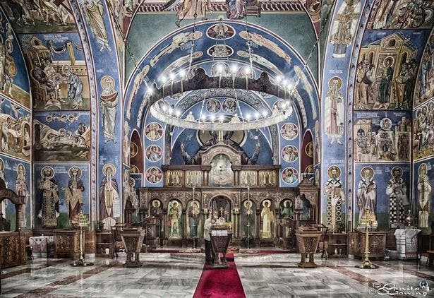 Ornate church interior with vibrant frescoes, ideal for weddings and events.