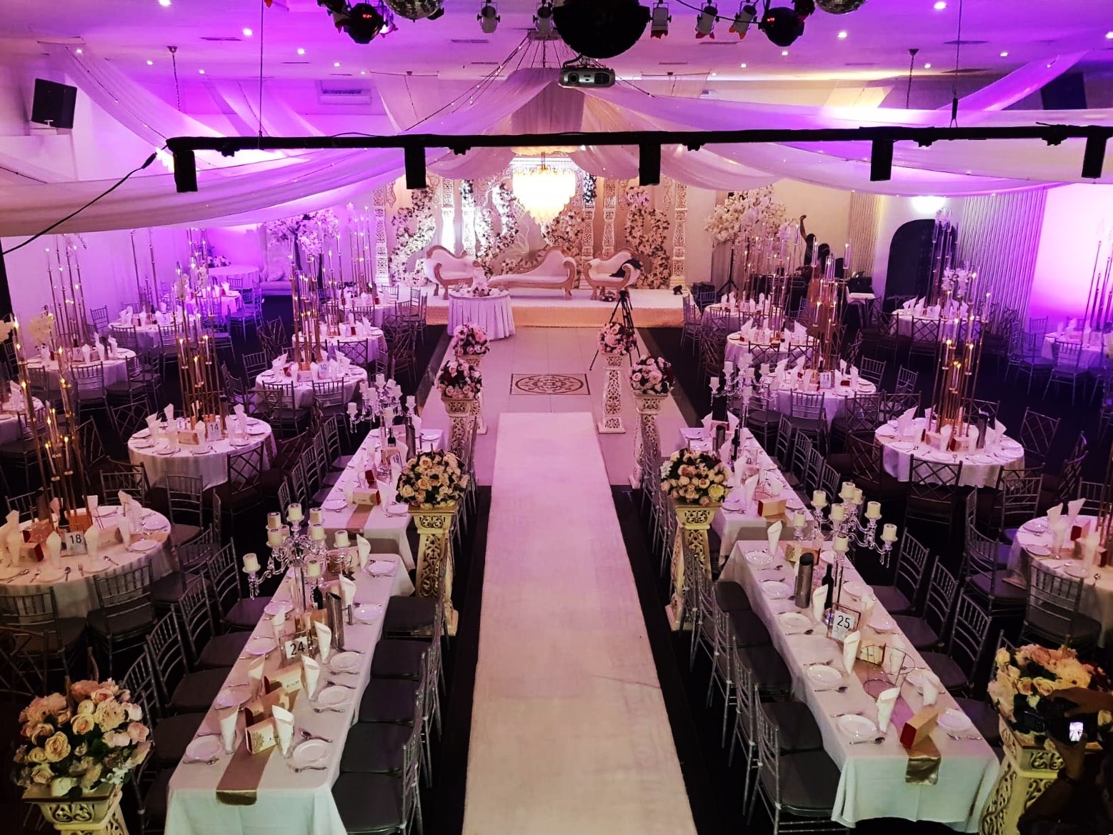 Elegant event space with floral centerpieces, perfect for weddings and galas. - Banner