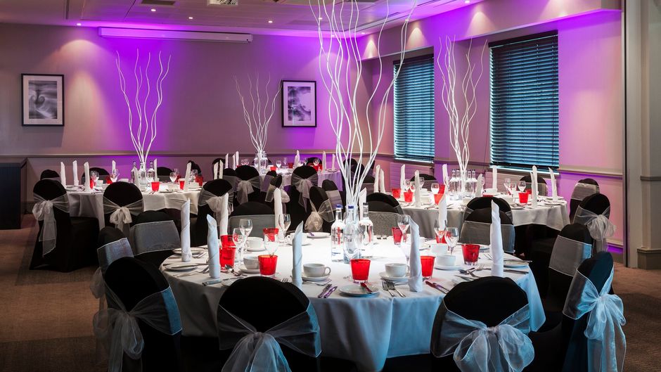 Oasis Suite banquet room with elegant tables, ideal for weddings and corporate events. - Banner