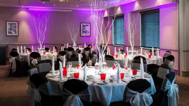 Oasis Suite banquet room with elegant tables, ideal for weddings and corporate events.