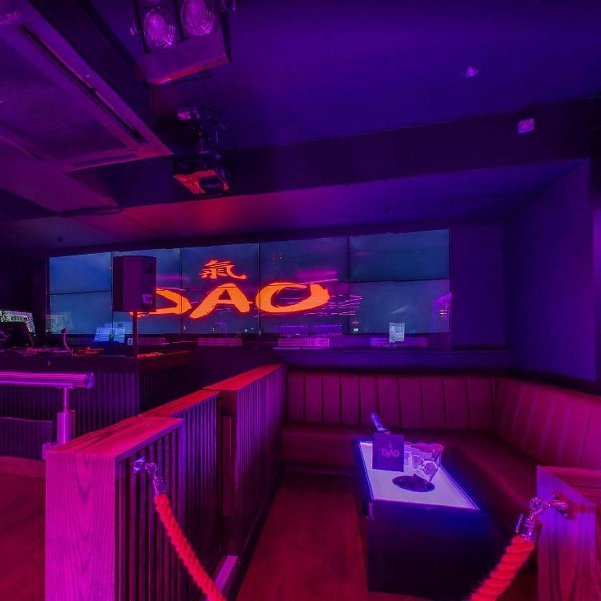 Vibrant event space in Rosies Birmingham with illuminated "DAO" backdrop for networking events.