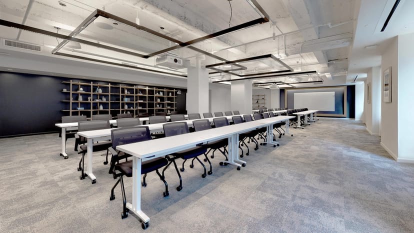 Modern meeting space with long tables, ideal for workshops and training sessions.