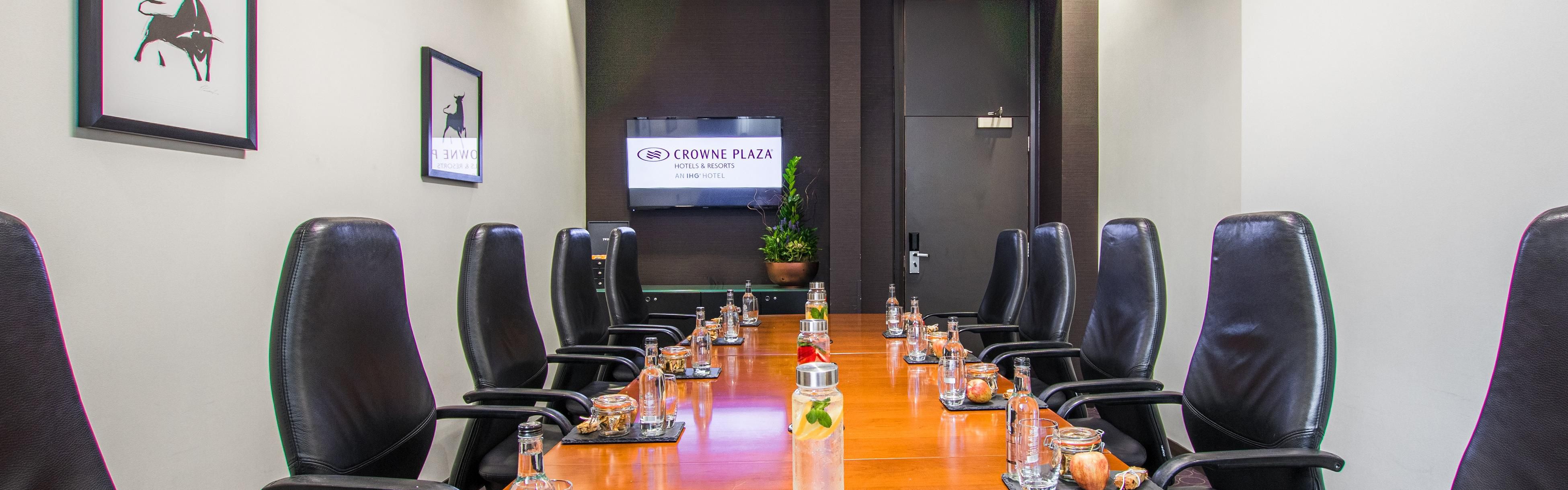 Meeting room at Crowne Plaza Birmingham with sleek table, ideal for corporate events. - Banner