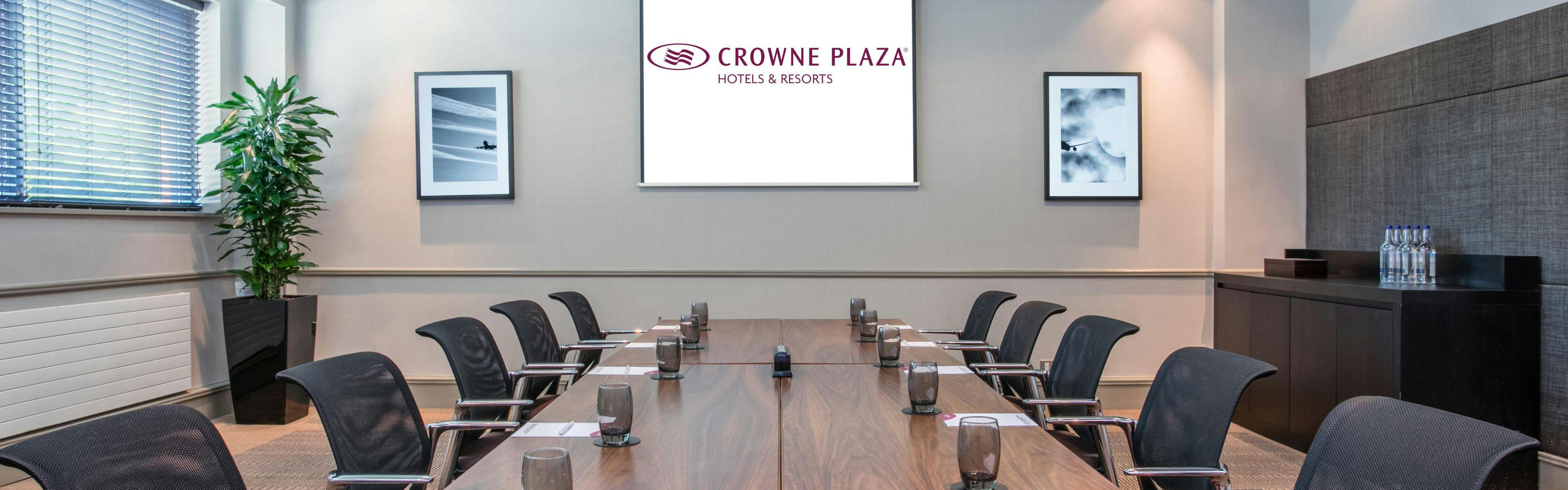 Conference room at Crowne Plaza Birmingham, featuring a large wooden table for corporate meetings.