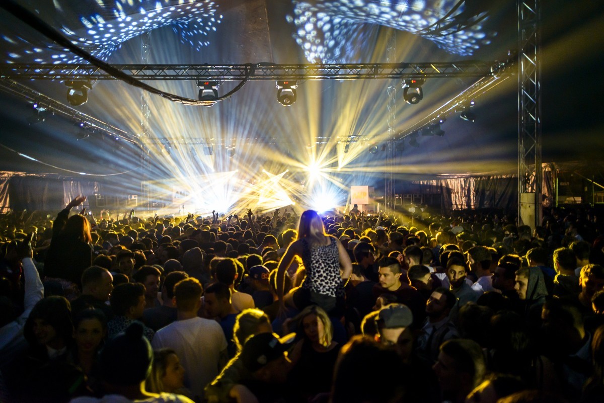 Vibrant nightclub crowd with dynamic lighting at The Electric event. - Banner