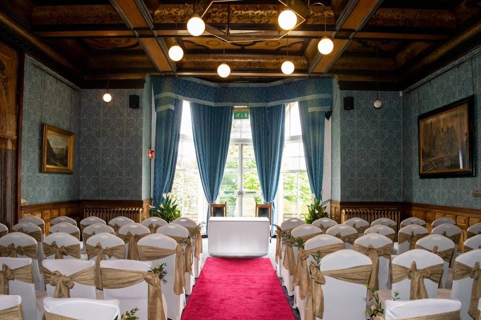 Elegant bar area with blue drapes, ideal for weddings and formal events.