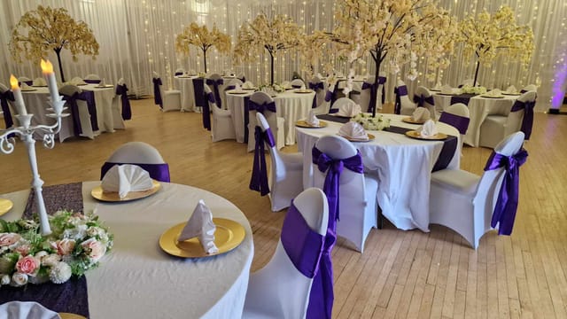 Ballroom at The Civic, Stourport: elegant wedding venue with white drapes and purple accents.