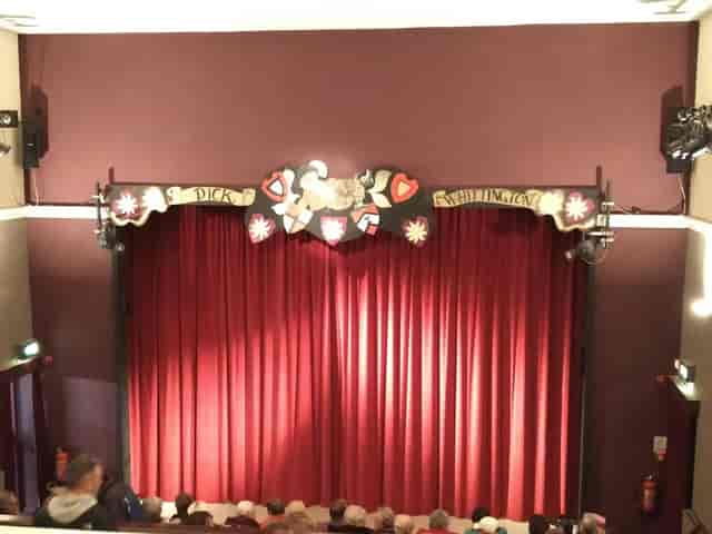 Studio Theatre stage with red curtain, perfect for intimate performances and events.