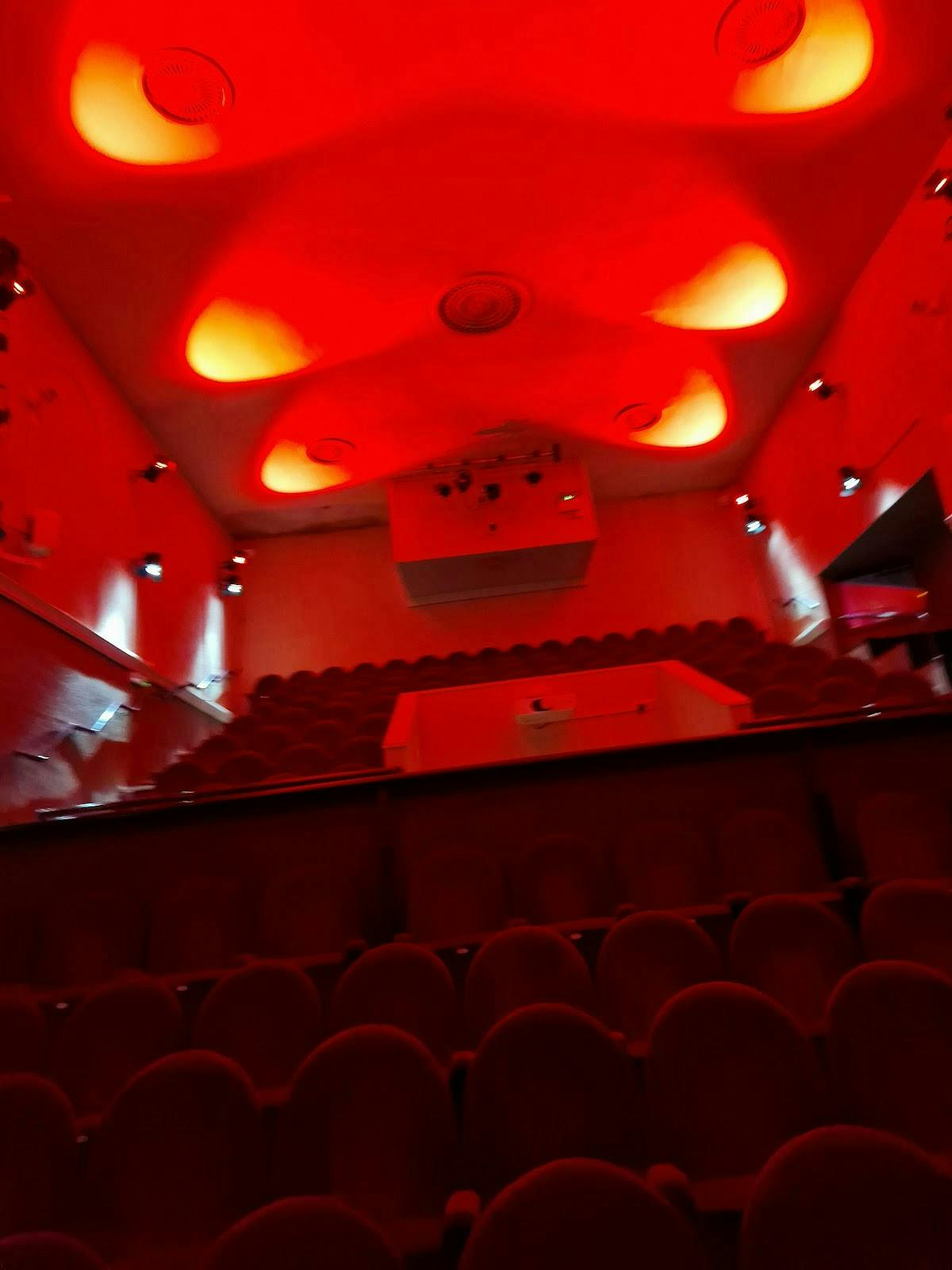 Studio Theatre in Oldbury: tiered seating and dramatic red lighting for performances.