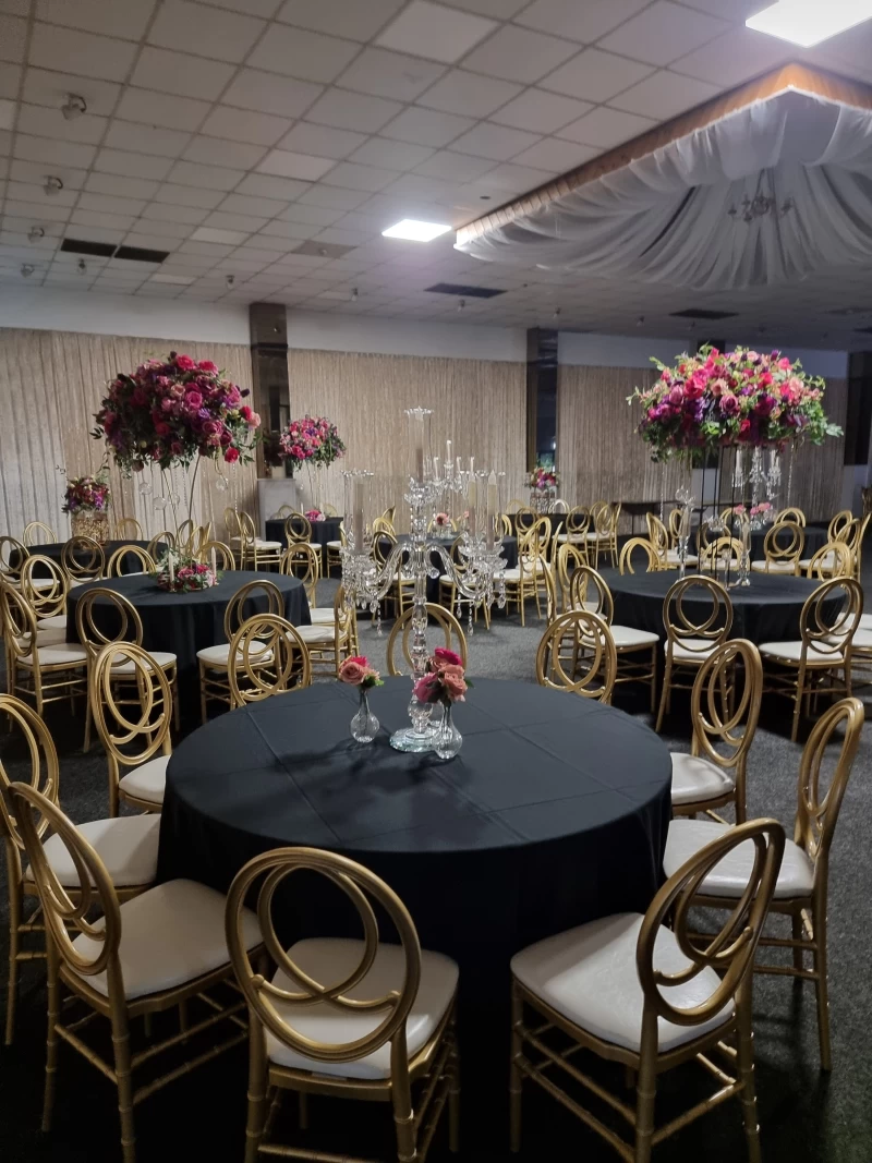 Elegant banquet hall with floral centerpieces for upscale events and celebrations. - Banner
