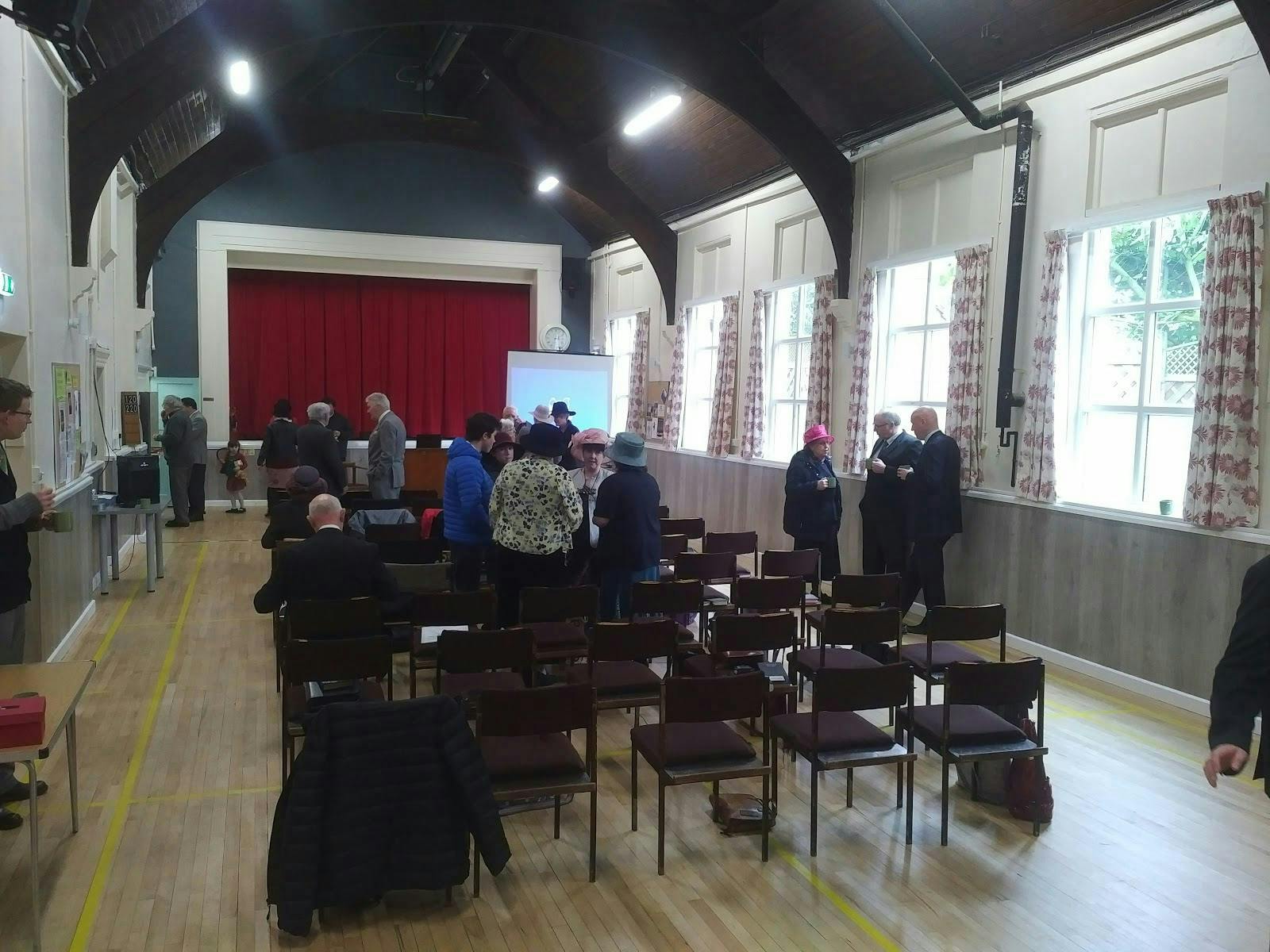 Earlswood Village Hall Main Hall setup for community networking event with red curtains.