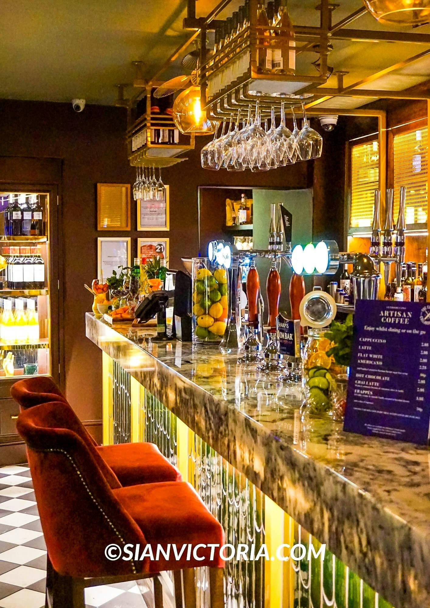 Stylish bar with marble counter, ideal for networking events and cocktail receptions.
