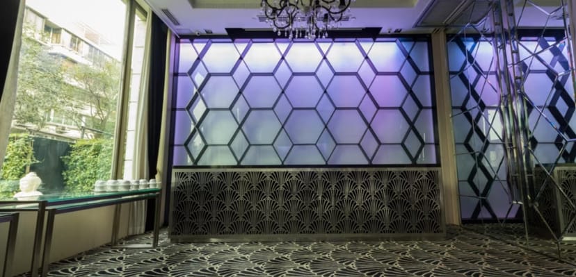 Modern event space at InterContinental Marine Drive, hexagonal backdrop for meetings and receptions.