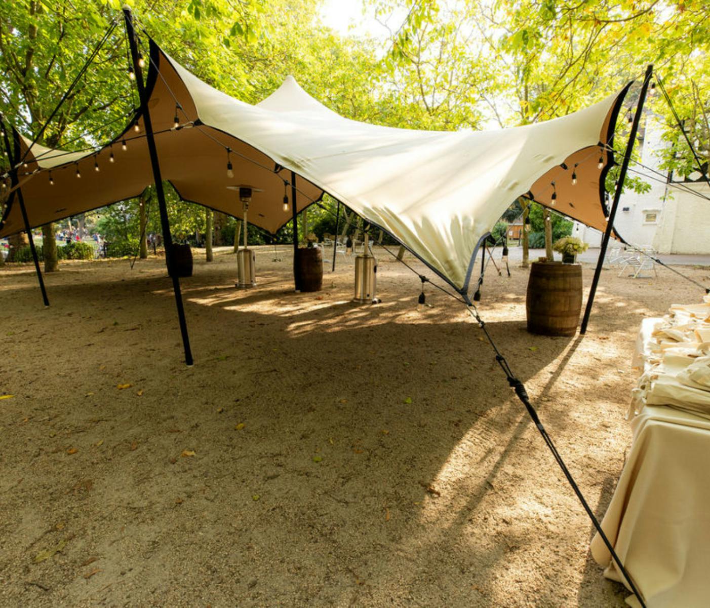 Elegant outdoor event space with tension fabric canopies, ideal for weddings and gatherings.