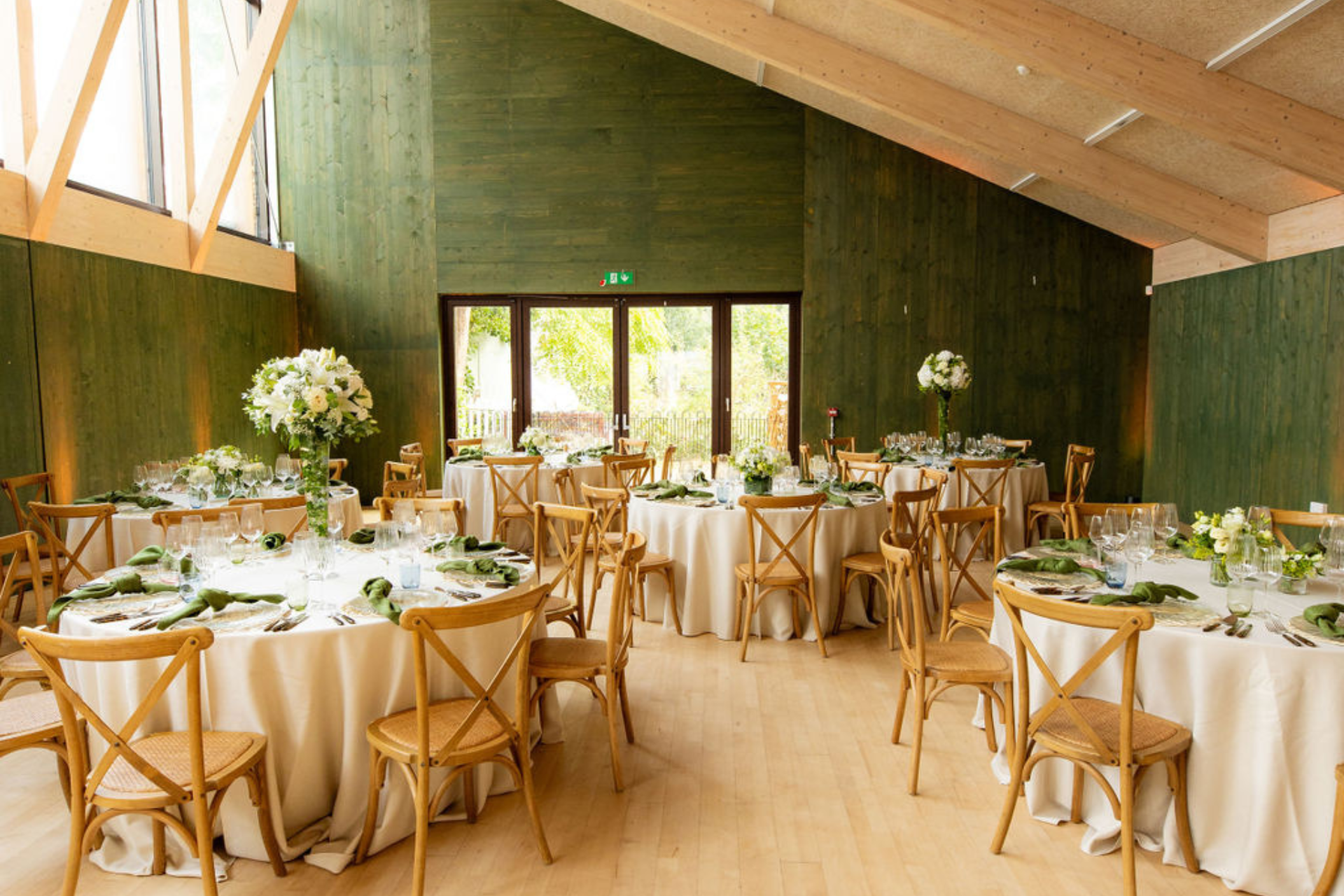 Elegant event space with round tables, ideal for weddings and upscale gatherings. - Banner