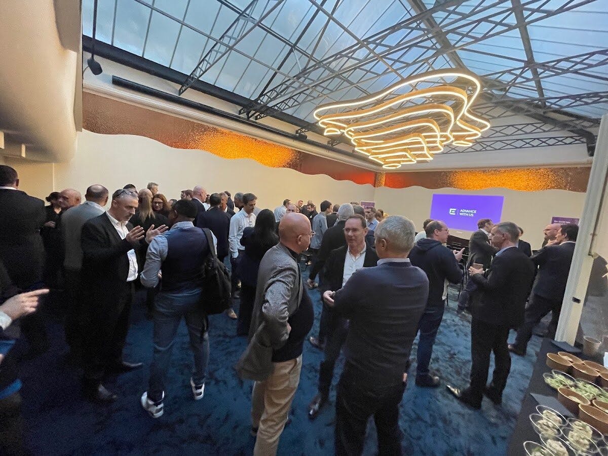 Vibrant networking event in stylish Maison Boétie with modern decor and engaged attendees.