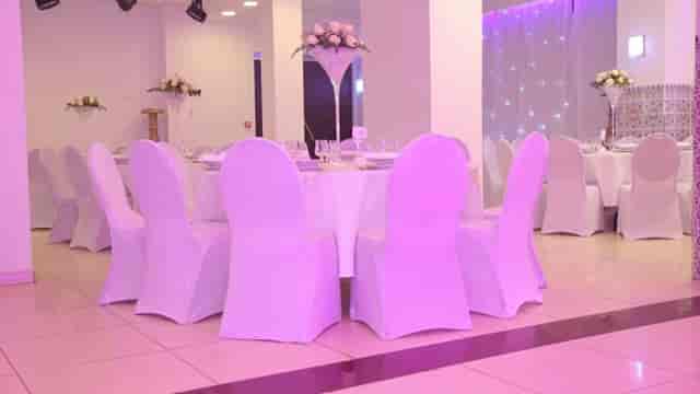 Elegant reception hall with draped tables, perfect for weddings and corporate events.