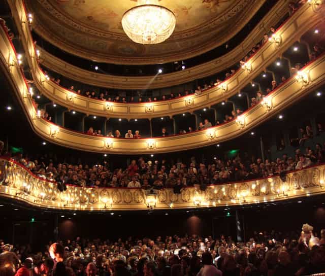 Elegant Théâtre du Gymnase theater with tiered seating, perfect for performances and events.