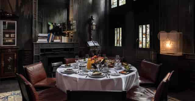 Elegant round table in Les Bains Paris atrium, perfect for upscale dinners and events.