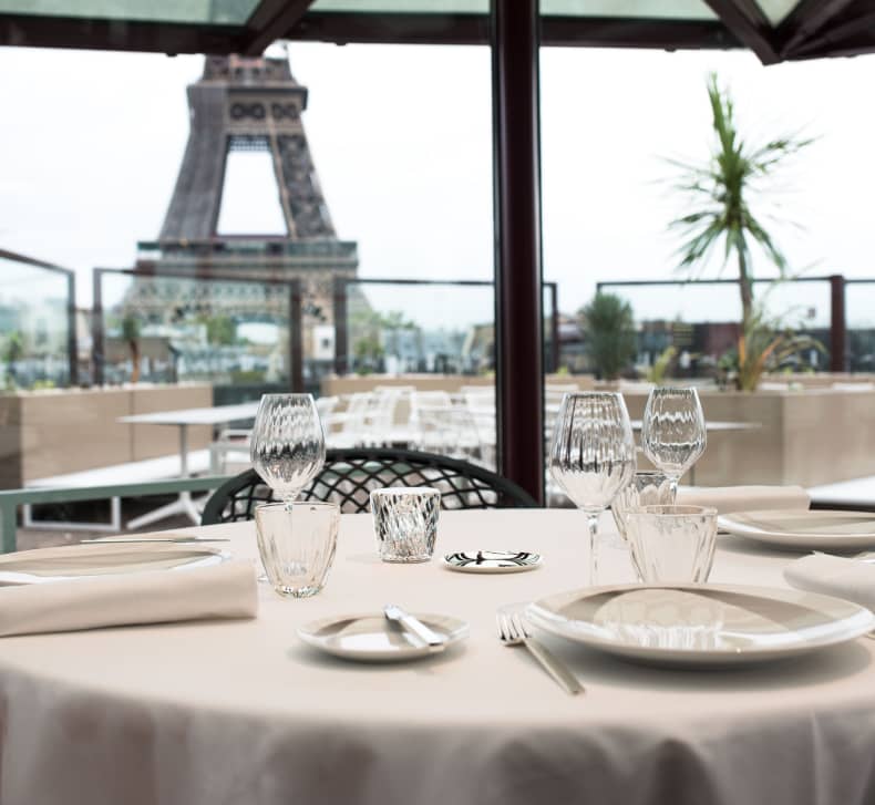 Elegant dining table at Les Ombres restaurant with Eiffel Tower view, perfect for events.