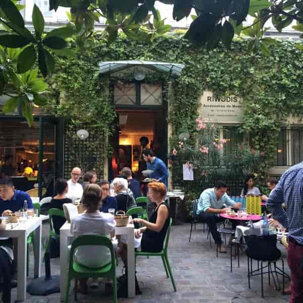 Outdoor terrace at Derrière with greenery, ideal for networking events and workshops.