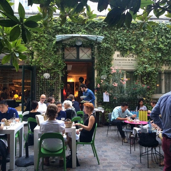 Outdoor terrace at Derrière with greenery, ideal for networking events and workshops.
