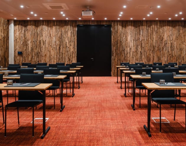 Meeting room in Sly Berlin with warm wood paneling, ideal for events and presentations.