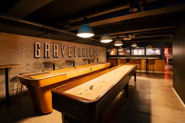"Rustic event space with shuffleboard tables for casual gatherings and team-building."