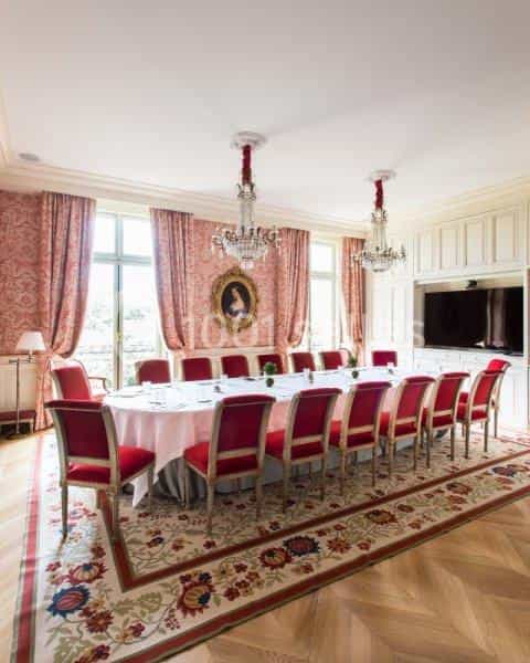 Antonin Carême in Le Clarence meeting room with plush red chairs, ideal for executive retreats.
