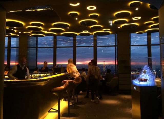 Sophisticated Ciel de Paris restaurant with panoramic skyline views for upscale events.